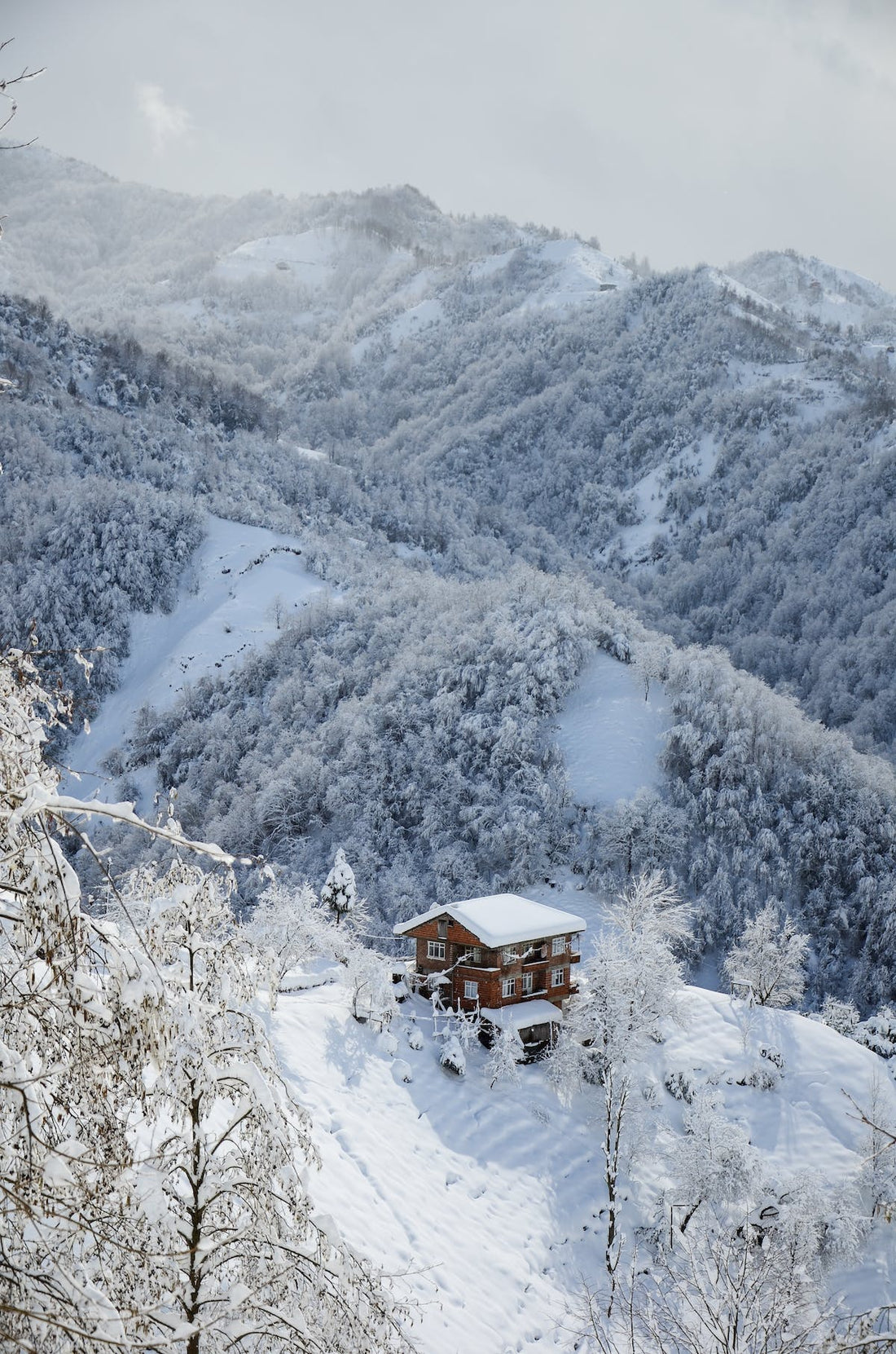 Alpine view of cabin in the snowy mountain